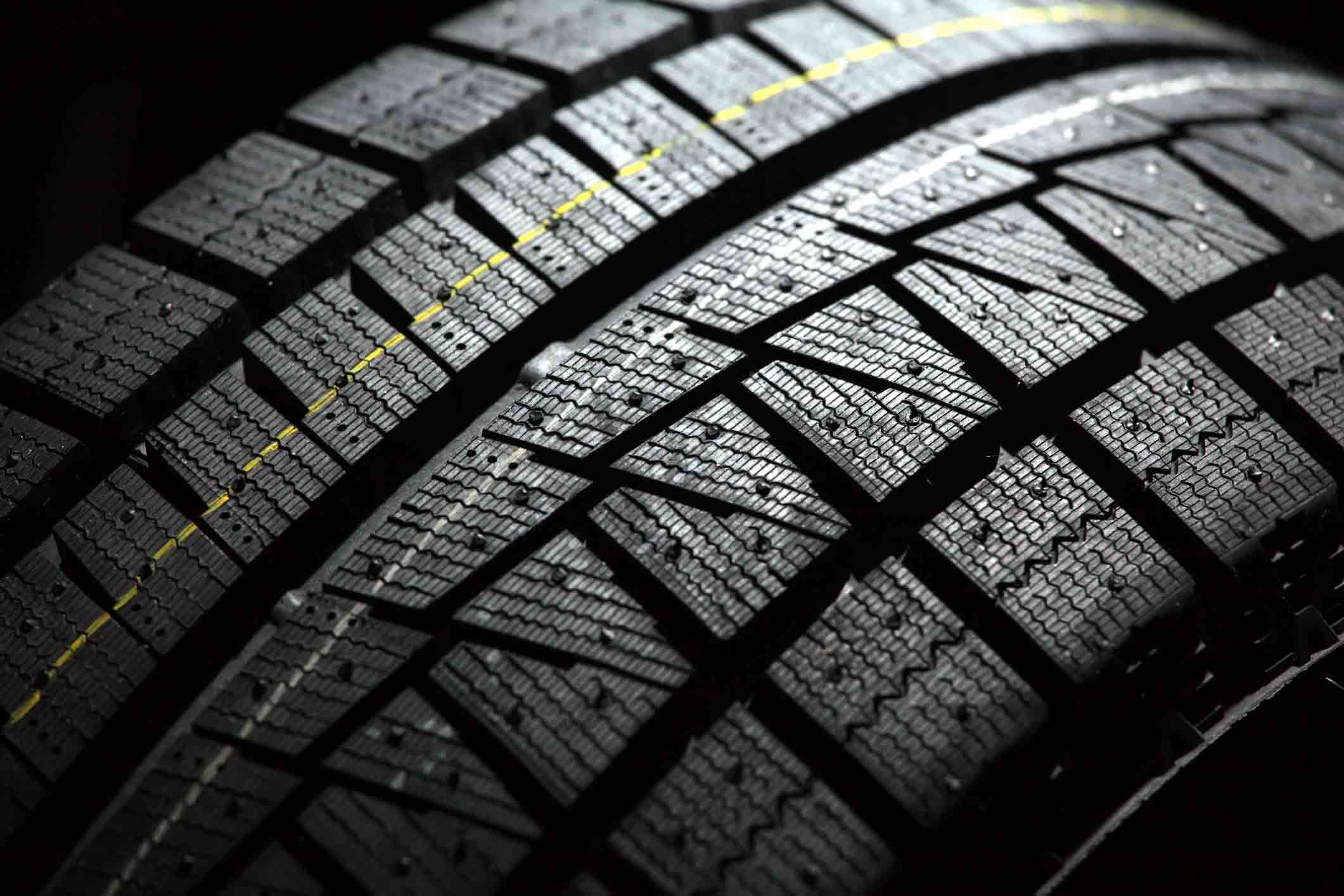 dreamstime_m_22061143 Part of brand new car tyre. Shallow DOF. Black back background.