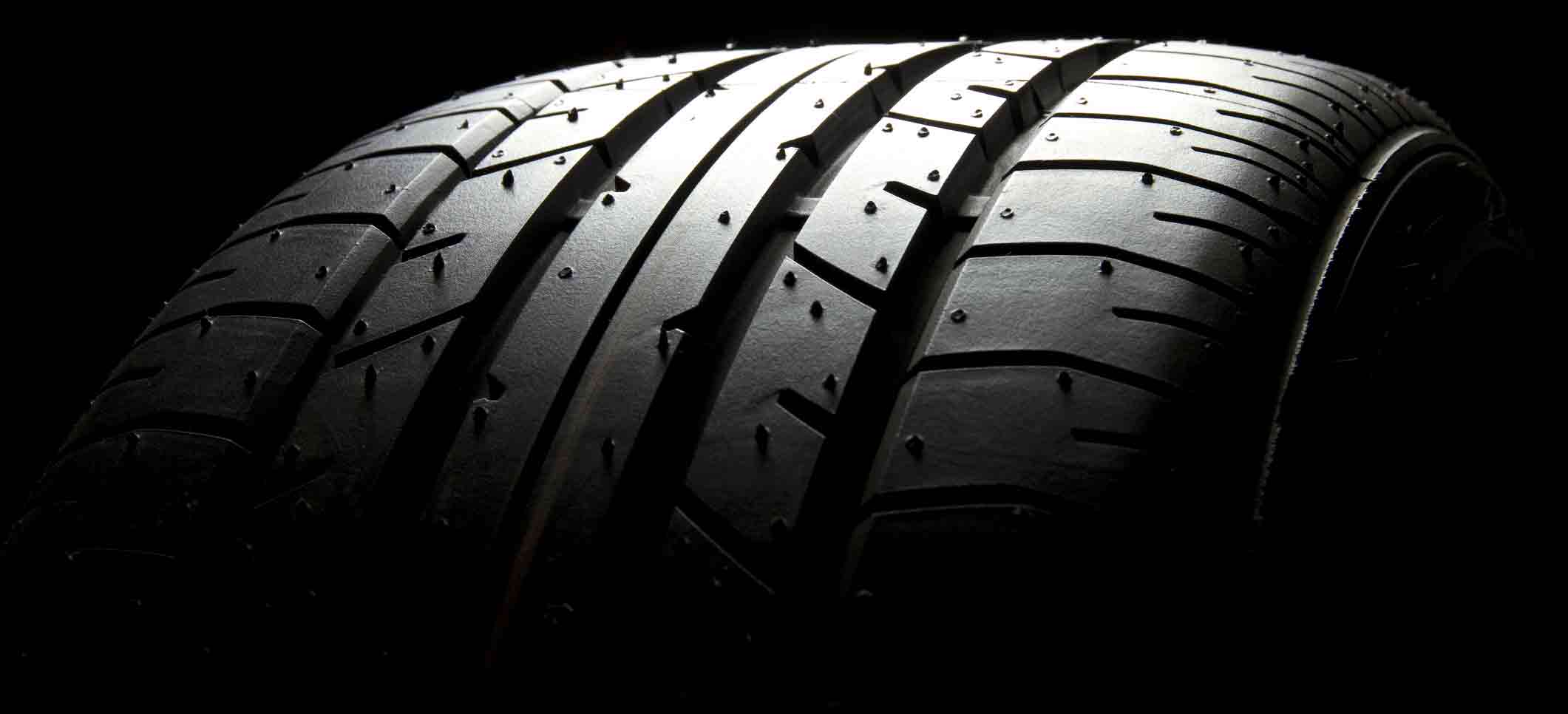 dreamstime_m_24934340 Brand new car tire on black